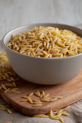 Organic Dried Orzo Pasta in a Bowl, side view. Close-up.