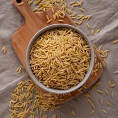 Organic Dried Orzo Pasta in a Bowl, top view. Close-up.