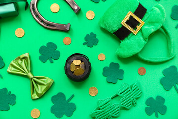 Pot with golden coins, leprechaun hat and horseshoe on green background. St. Patrick's Day...