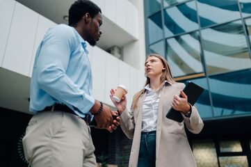 Businesspeople discussing work outside office building