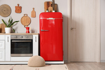 Interior of kitchen with red fridge and white counters