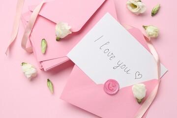 Stack of letters, card with phrase I Love You and flowers on pink background, flat lay