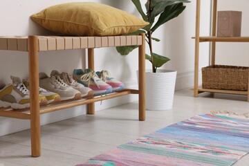Different footwear on shelf in hallway indoors