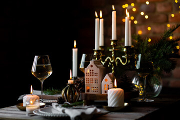 Elegant decor for Christmas family dinner. Center piece with burning candles, vintage chandelier....