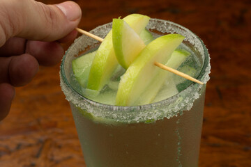 Refreshing Green Apple Martini (Appletini) cocktail with a sugar rim and fresh apple garnish, a...