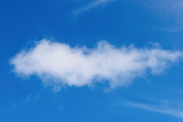 A solitary, bright white cumulus cloud floats in a clear blue sky, typical of the São Paulo...