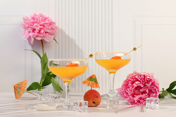 Modern still life with ice punch with apricots, summer alcoholic cocktail for party and peonies on...