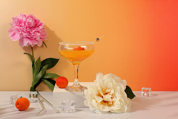 Iced punch with apricots for party,Modern still life with summer alcoholic cocktail and peonies on...