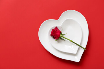 Beautiful table setting with red rose on color background. Valentine's Day celebration