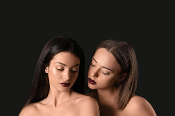 Two different naked young women on black background. Yin Yang concept