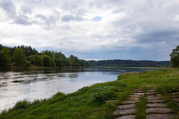 Peaceful Nemunas River Bank with Grassy Path and Forest, Lithuania