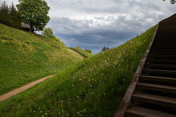 
Dramatic Clouds Over Merkine Hillfort with Winding Paths, Lithuania