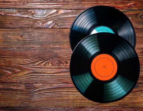 colorful vinyl records on rustic wood background