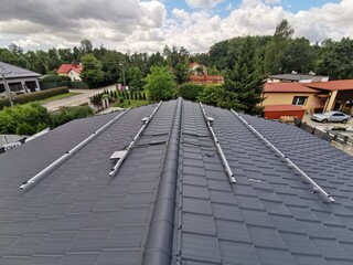 The structure on the house's roofing felt for installing solar panels, with microinverters also installed