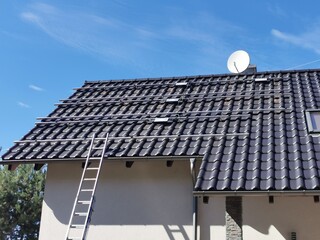 The structure on the house's roofing felt for installing solar panels, with microinverters also installed