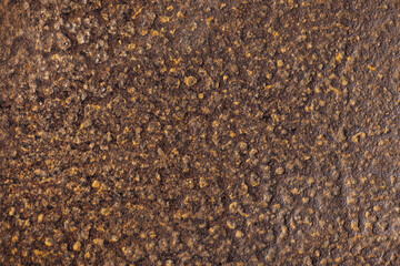 Rough, rust covered textured surface featuring an intricate pattern