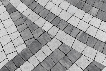 Geometric pavement design with alternating dark and light tiles, background