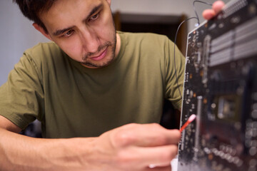 A Close Up View of a Hand Engaged in the Process of Cleaning a Circuit Board Component