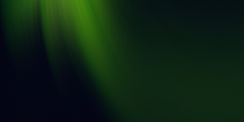 Soft green light rays shining down on a dark background
