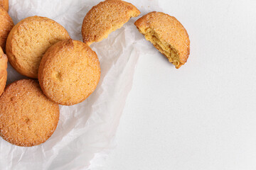 Baking paper with sweet cookies on white background