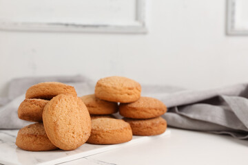 Board with sweet cookies on white background
