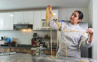 Chef holding fresh homemade pasta in restaurant kitchen