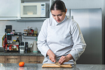 Professional chef cutting garlic in a modern kitchen