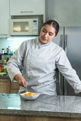 Latin chef preparing pasta in a modern kitchen