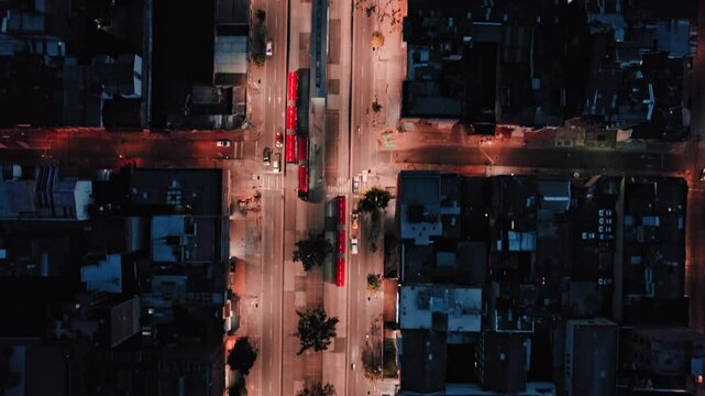 Top-down drone view of Bogot&aacute; streets with TransMilenio buses at night &ndash; Bogot&aacute;, Colombia