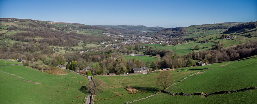 aerial panoramic view of the calder valley with the village of mytholmroyd visible surrounded by meadows and trees
