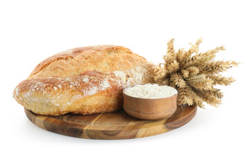 Board with loaf of fresh bread, wheat ears and flour isolated on white background