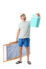 Happy young man with portable fridge for beer and deckchair isolated on white background