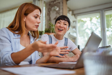 multicultural female friends discussing and working or teaching at home