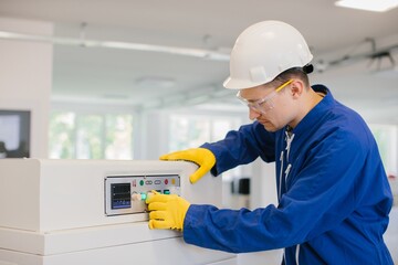 Industrial worker operating machinery in factory setting