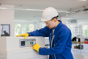 Technician operating industrial machinery in modern factory setting