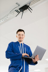 Technician installing or maintaining wireless router using laptop