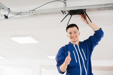 Technician installing wireless router and giving thumbs up