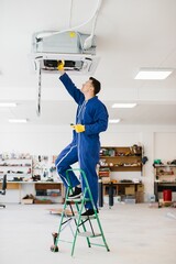 Technician repairing air conditioner unit on a ladder