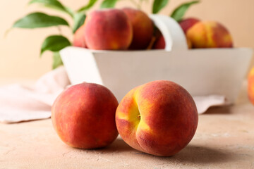 Sweet ripe peaches on beige background