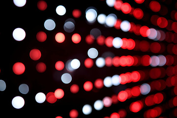 Abstract Luminescence: An artistic portrayal of vibrant red and white bokeh lights against a sleek black backdrop, creating a mesmerizing visual experience.