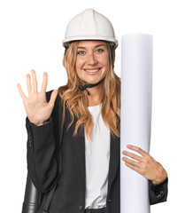 Blonde architect with plans in studio smiling cheerful showing number five with fingers.