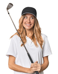 Blonde golfer holding a club in studio