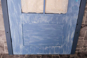 Weathered blue wooden door with rustic texture and vintage charm.