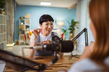 under the shoulder view of japanese host record podcast at home studio