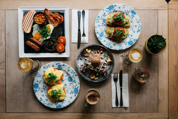 A table with plates of food and drinks, including a plate of waffles