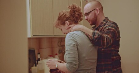 A loving couple spends quality time together in the kitchen, baking and enjoying each other's company. The warm lighting and intimate setting create a cozy atmosphere. - Powered by Adobe