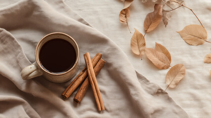 Cozy coffee flatlay with cinnamon sticks