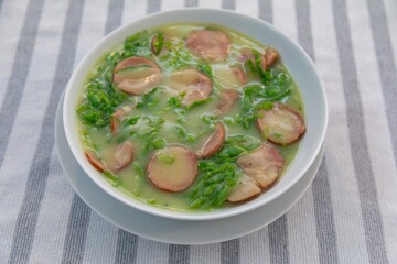 Traditional winter soup known as Portuguese green broth prepared good potatoes, kale and sausage. The best Portuguese broth in the world