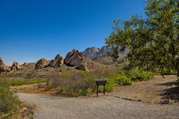 The Organ Mountains are a steep, angular mountain range with rocky spires that jut majestically...