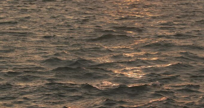Sunset over calm sea waters